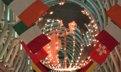 lighted globe with international flags surrounding